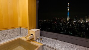 A modern bathroom with a wooden cabinet and a granite countertop. - Hotel East 21 Tokyo (Tokyo)