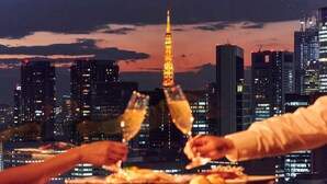 A cityscape with illuminated buildings and a prominent tower in the background. - Ginza Creston (Tokyo)