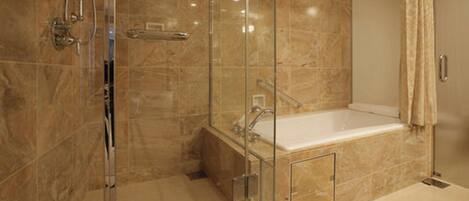 A modern bathroom with a glass-enclosed shower, a standalone bathtub, and a vanity with a mirror.