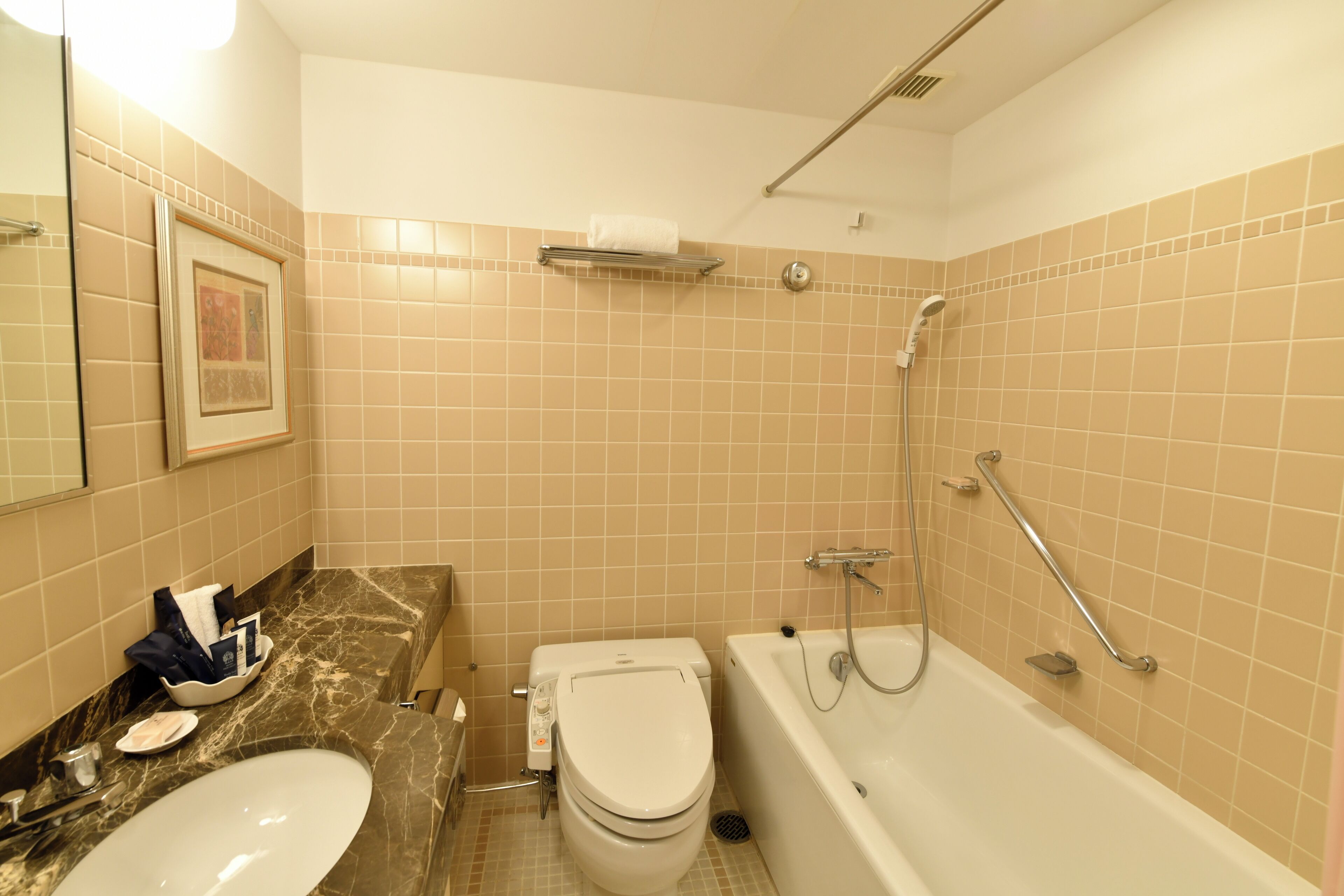A bathroom with a sink, toilet, and bathtub.