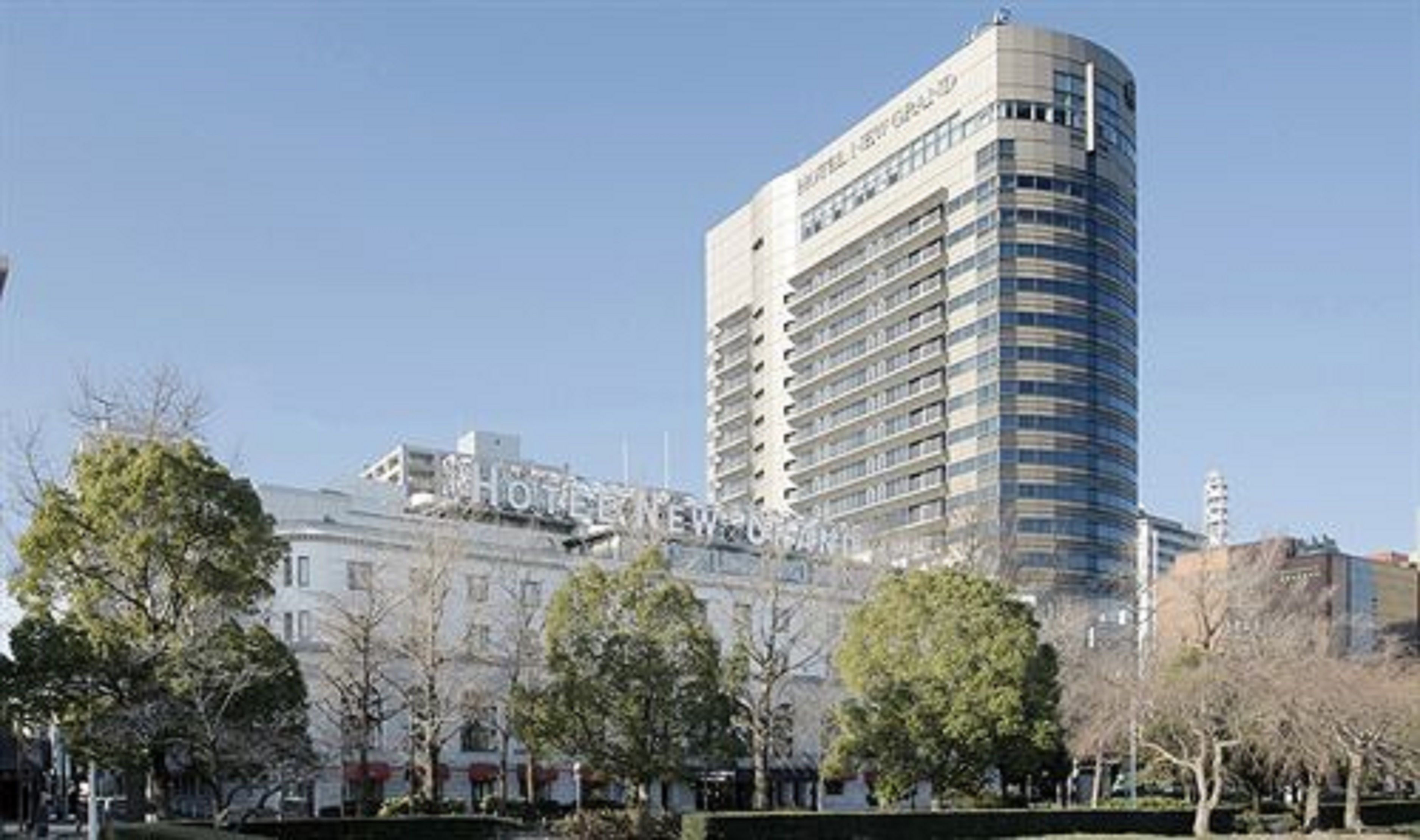 A modern hotel building with a curved facade and multiple floors.