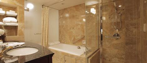 A modern bathroom with a glass-enclosed shower, a bathtub, and a vanity with a sink.