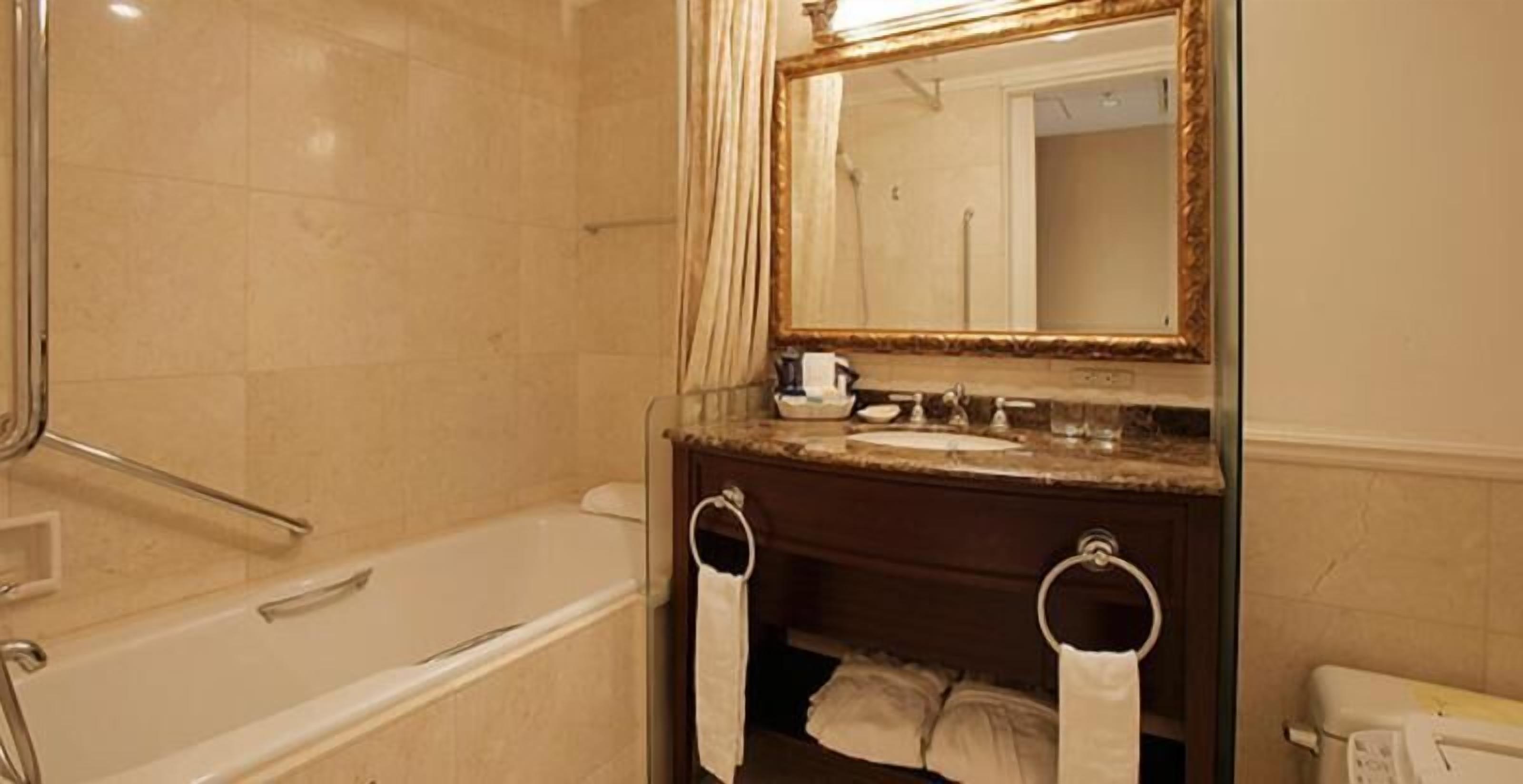 Combined shower/tub, designer toiletries, hair dryer, slippers