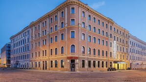 A historic building with a classic architectural style, featuring multiple stories, large windows, and a prominent entrance. - Eurostars Metropole (Riga)