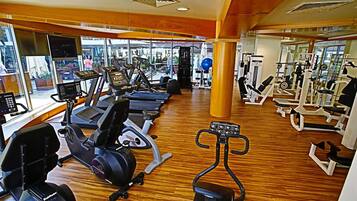 A gym with treadmills, stationary bikes, and weight machines.