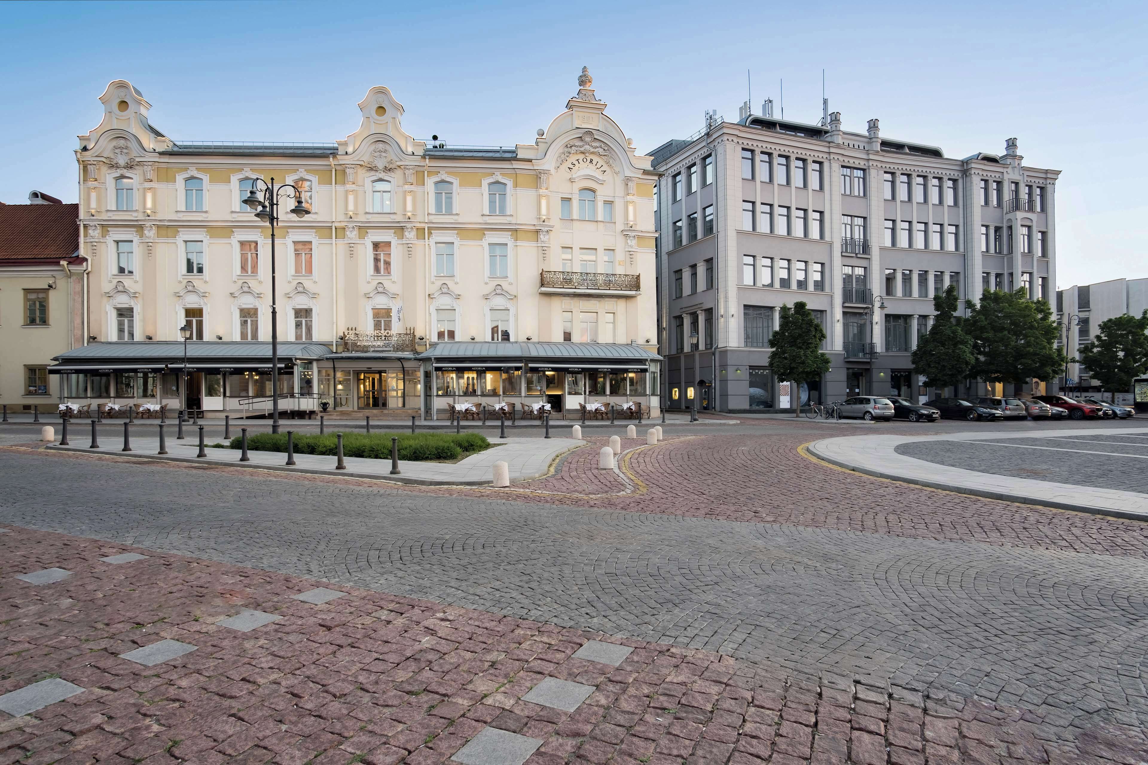 A historic building with a central entrance and a covered outdoor seating area.
