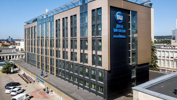 A modern hotel building with a prominent 'BW Best Western' sign, large windows, and a covered parking area. - Best Western Vilnius (Vilnius)