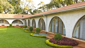 A building with arched windows and a well-maintained lawn. - Sunbird Lilongwe (Lilongwe)