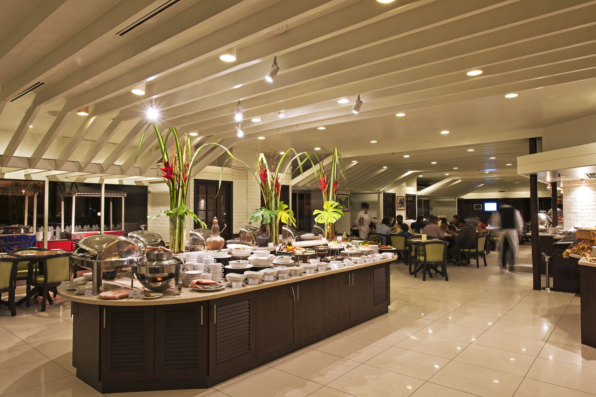 A buffet setup with a variety of food items and a central serving station.