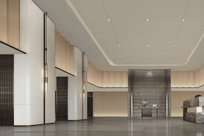 A spacious lobby with a reception desk, a decorative wall, and a modern ceiling design. - Courtyard by Marriott Kuala Lumpur City Centre (Kuala Lumpur)