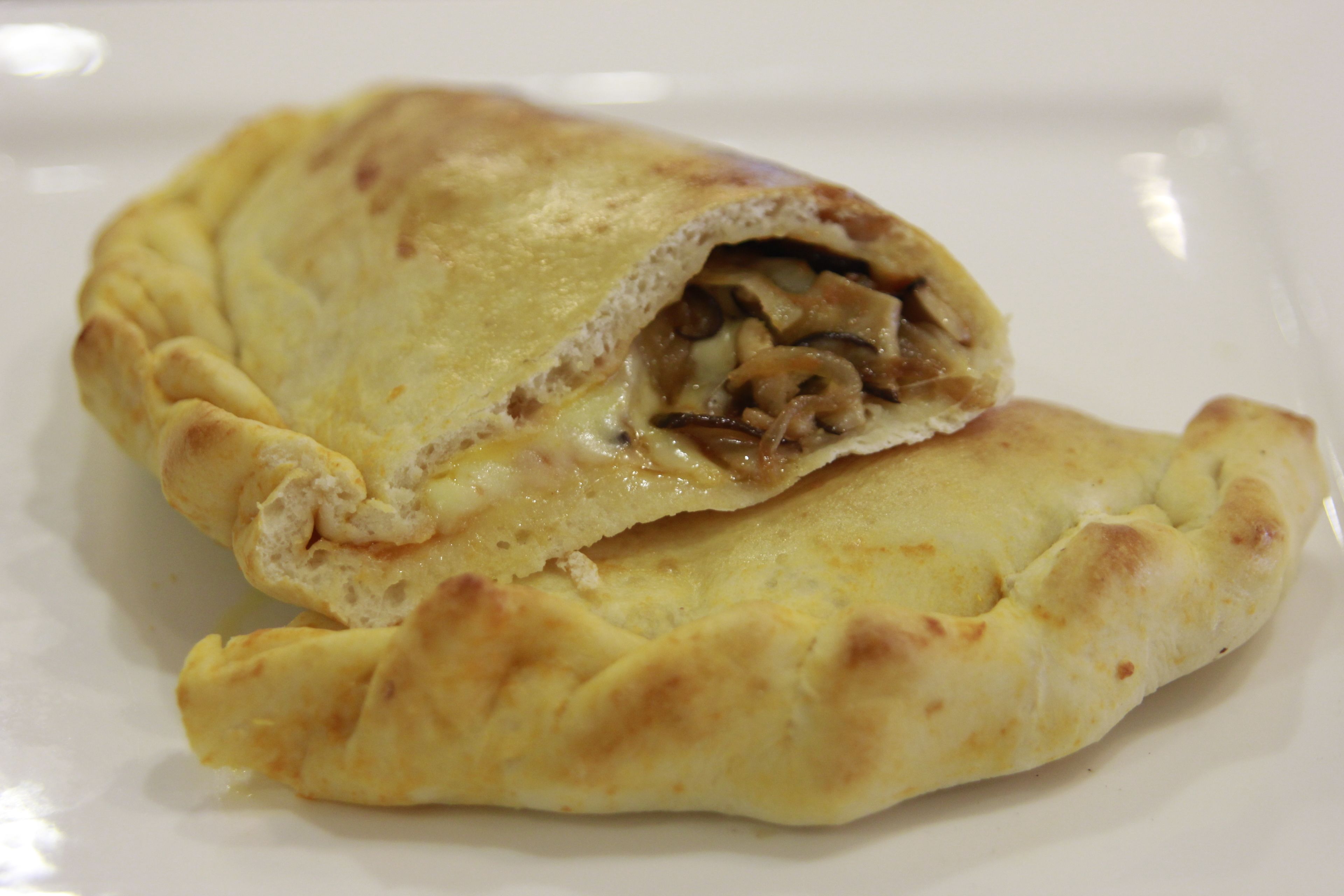 A stuffed pastry on a white plate.