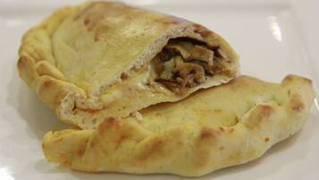 A stuffed pastry on a white plate.