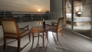A balcony with a table, two chairs, and a bottle of champagne. - Dorsett Grand Labuan (Labuan)