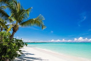 On the beach, white sand, free beach cabanas, sun-loungers