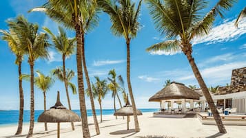 On the beach, white sand, free beach cabanas, sun-loungers