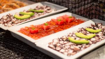 Three rectangular dishes with seafood and avocado garnishes on a textured surface.