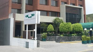A modern building with a sign reading "Palace Hotel".