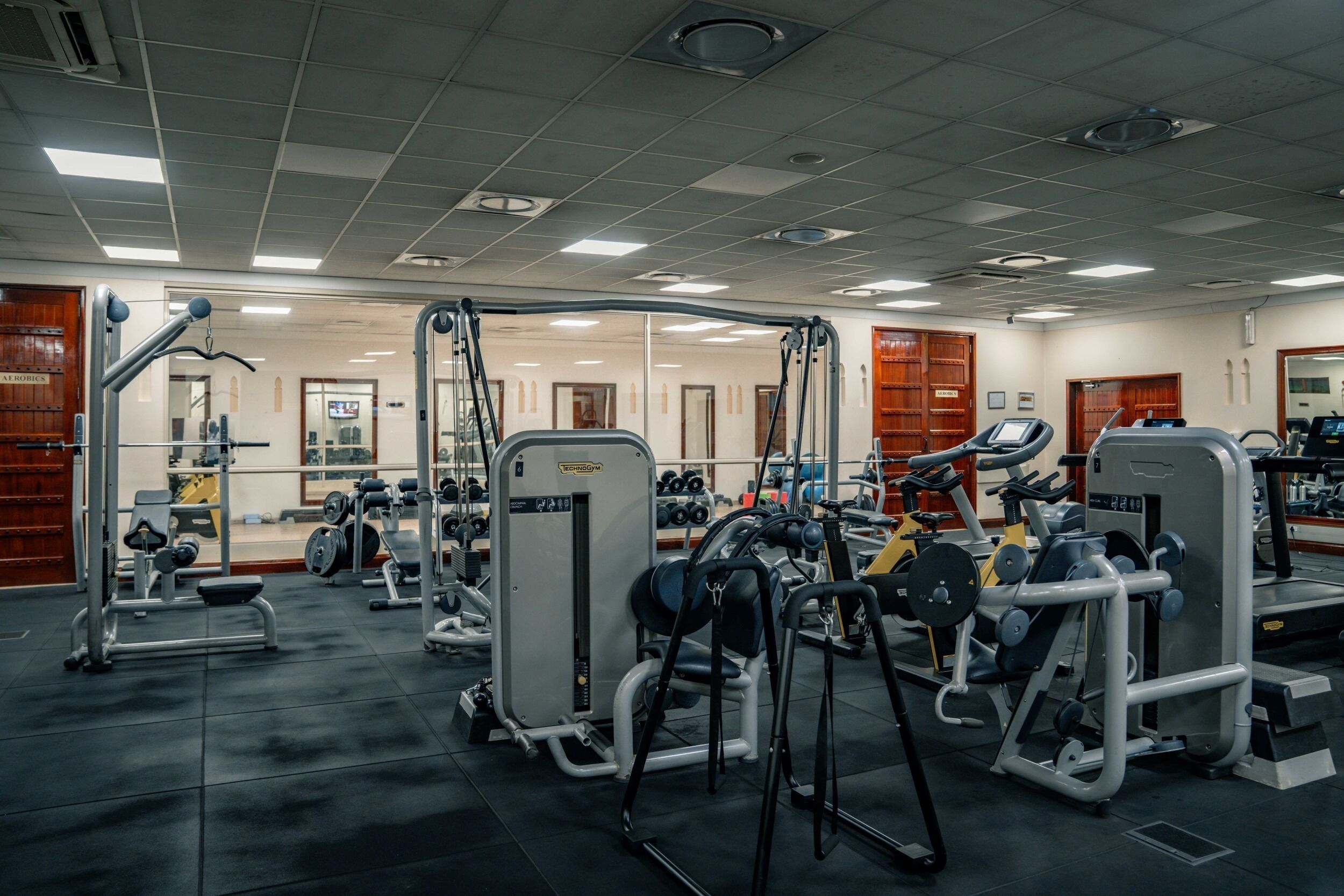 A gym with various exercise equipment, including weight machines and free weights.