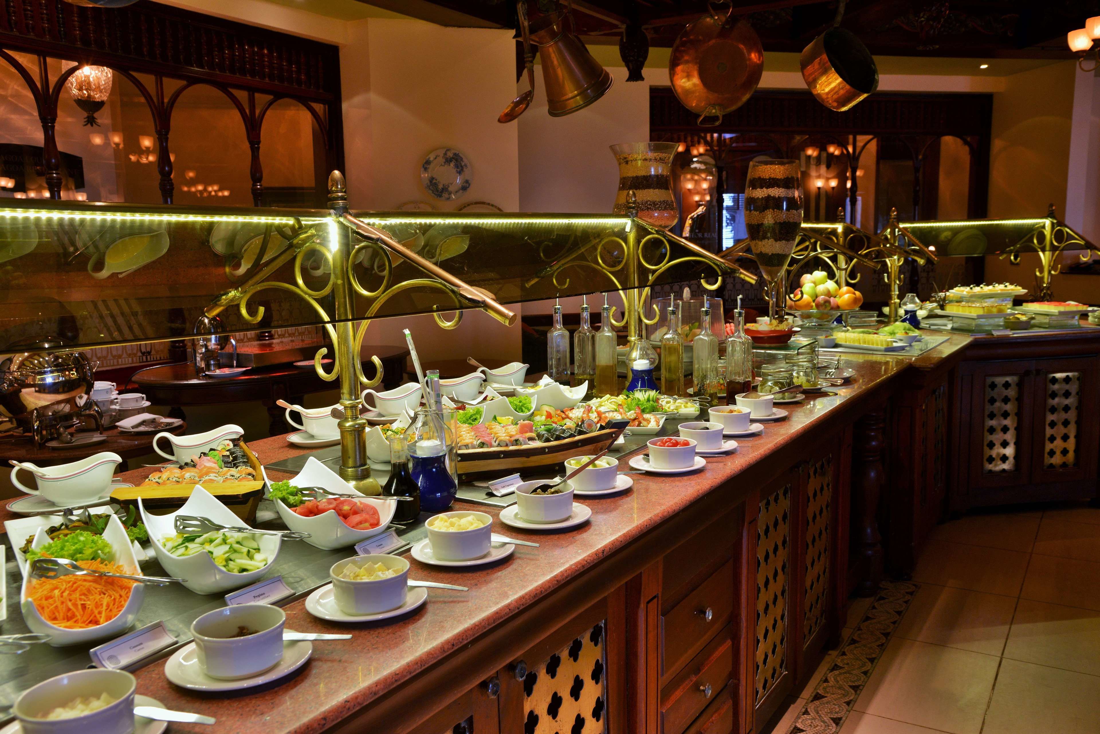 A buffet with various food items and beverages.