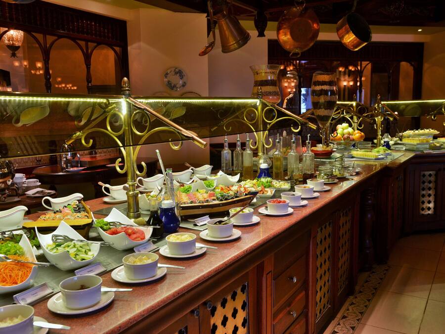 A buffet with various food items and beverages.