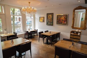 Enjoy dining in style with beautifully set tables and stunning views of the street outside.