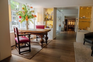 Enjoy a meal for two at the dining table, with a view of the outside through the large window.