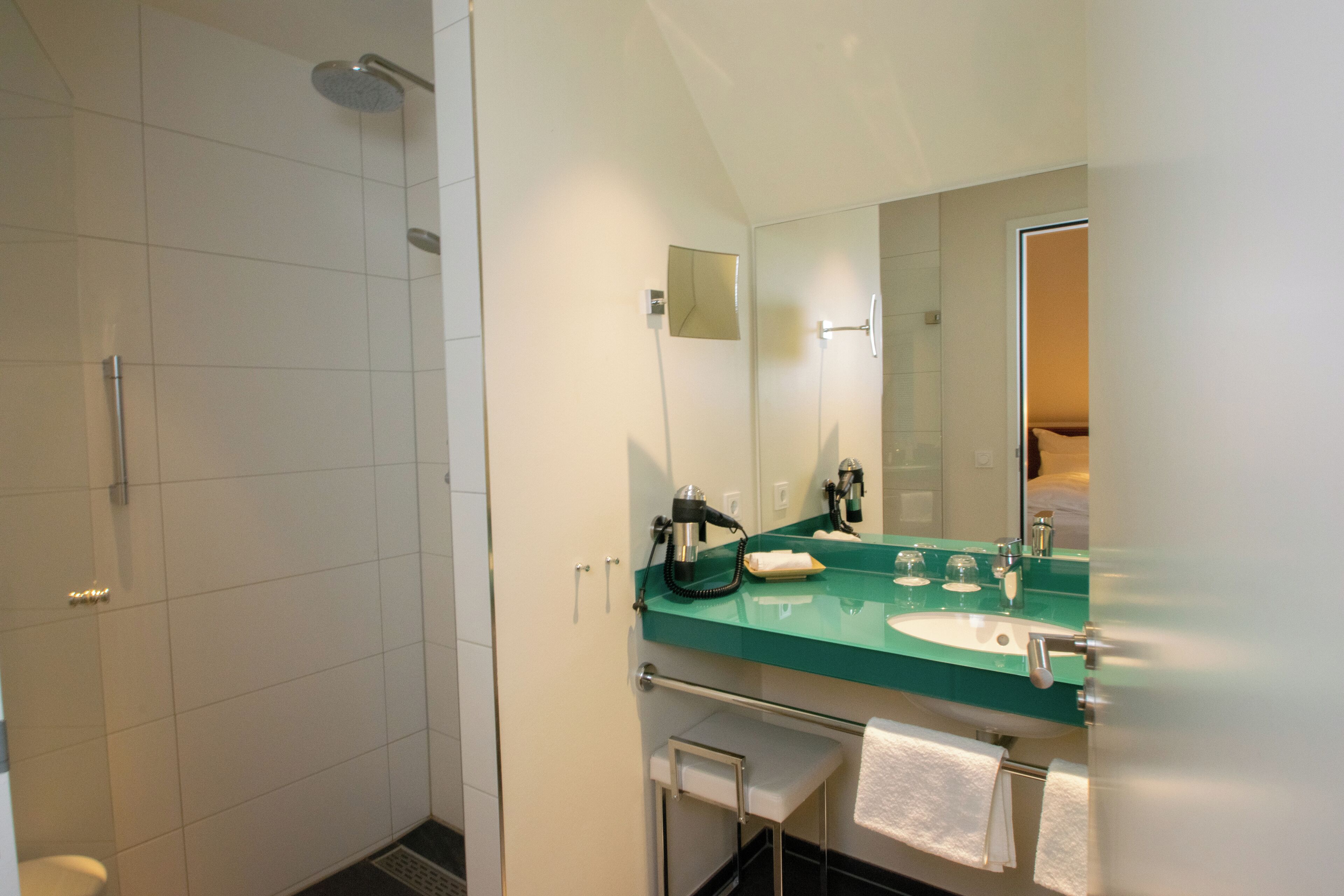 deluxe room | bathroom | shower, rainfall showerhead, free toiletries, hair dryer