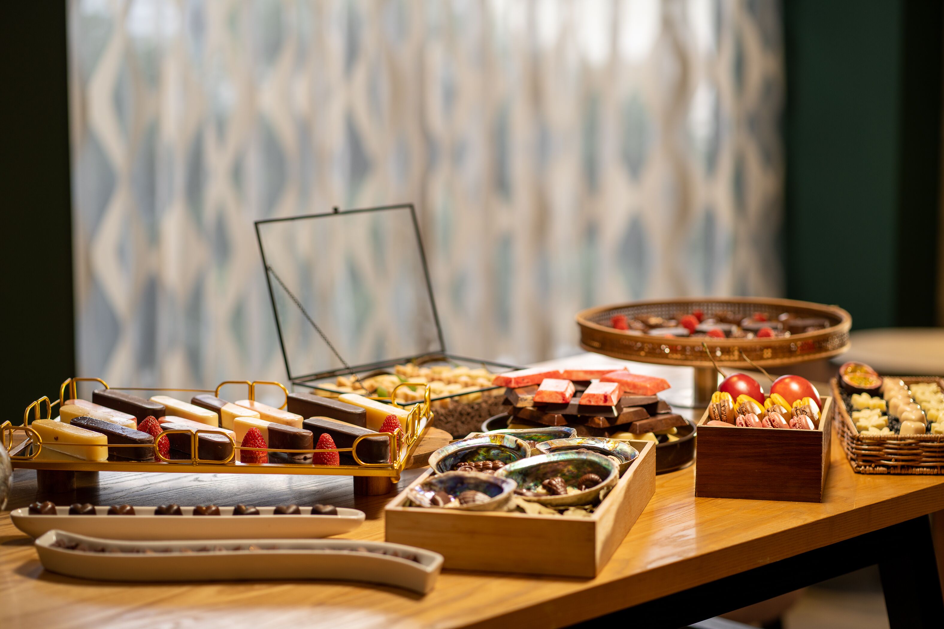 A buffet table with various food items and a small open display case.