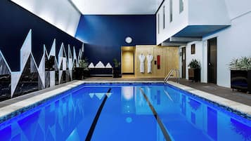 Swim and unwind in our indoor pool surrounded by a geometric light fixture wall and sauna.