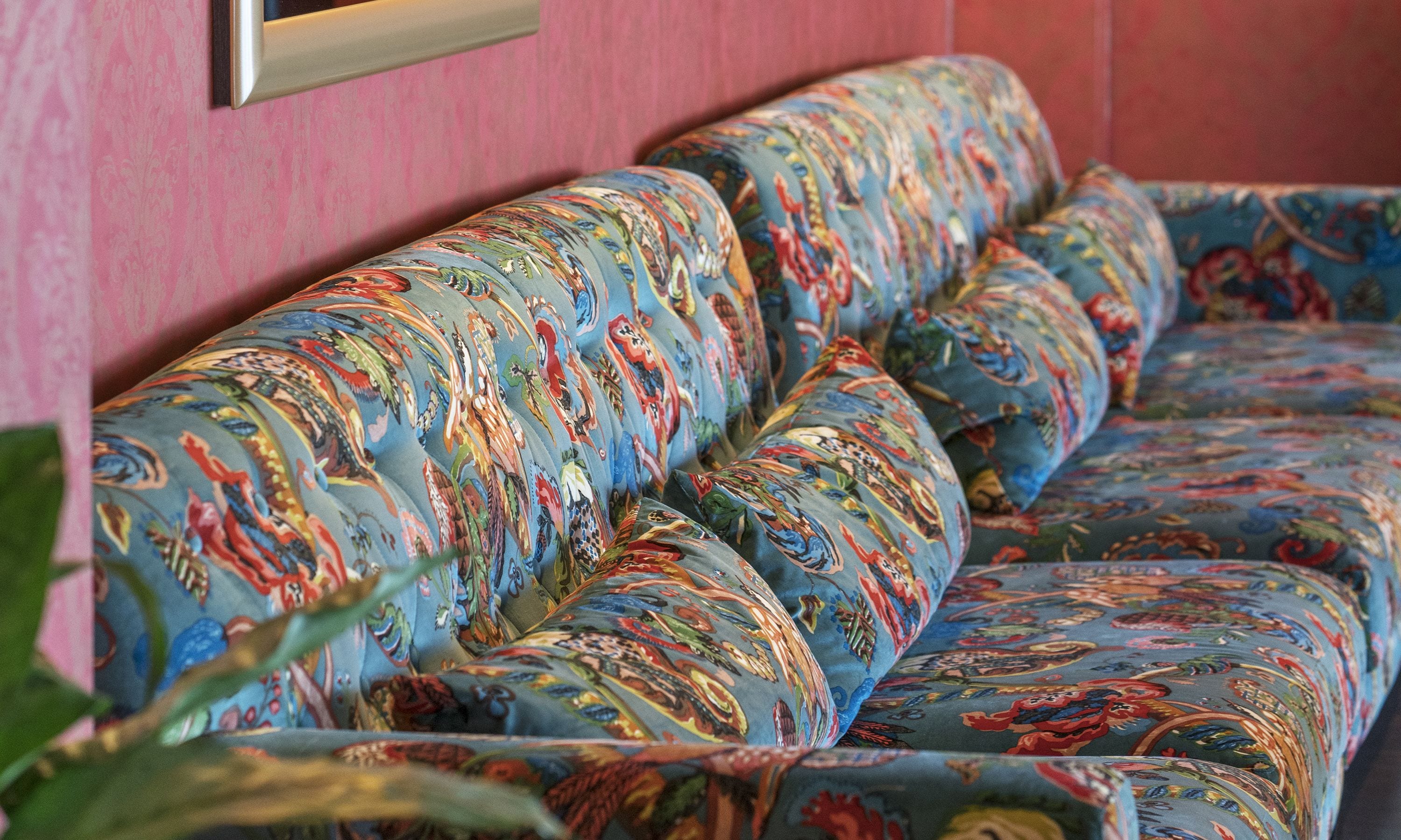 A sofa with a colorful, patterned fabric.
