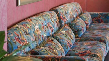 A sofa with a colorful, patterned fabric.