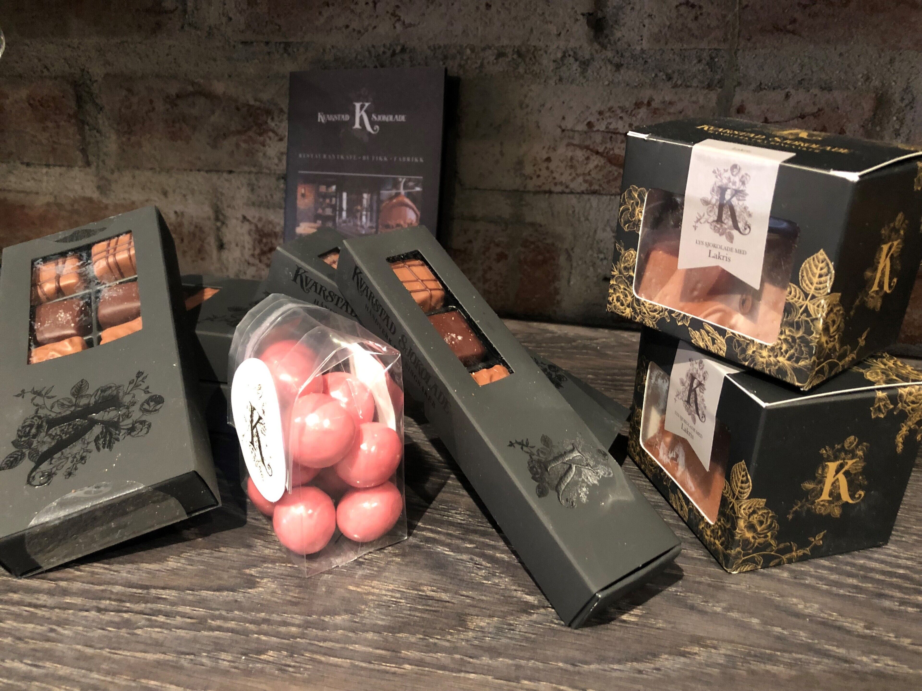 A collection of chocolate boxes with a rustic wooden background.