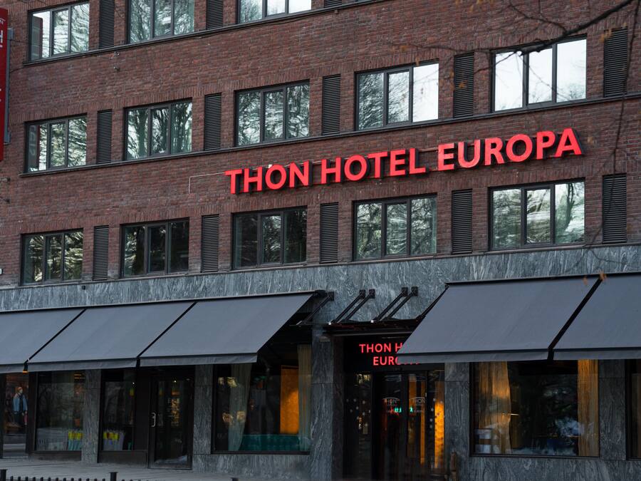 A hotel with a prominent red sign reading "Thon Hotel Europa".