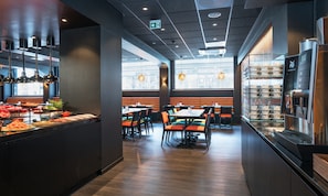 A modern restaurant interior with a buffet area, seating with orange cushions, and a yogurt display. - Thon Hotel Europa (Oslo)