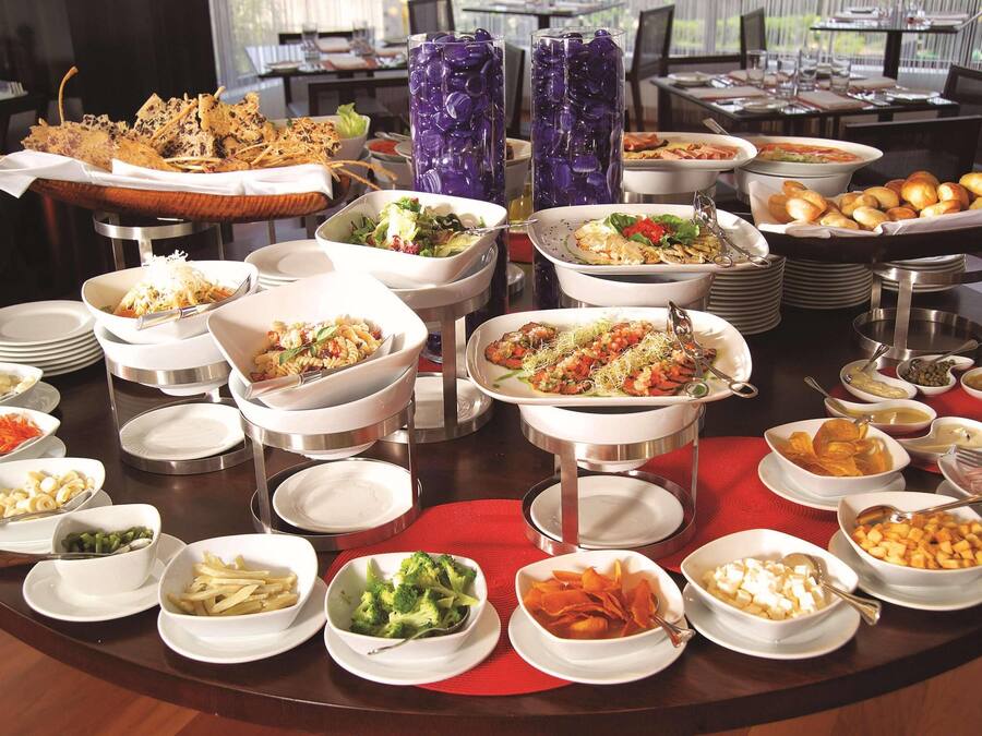 A buffet with various dishes and beverages.