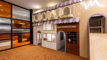 A reception area with a wooden facade, a reception desk, and a sign for 'mini WINESTONE.'