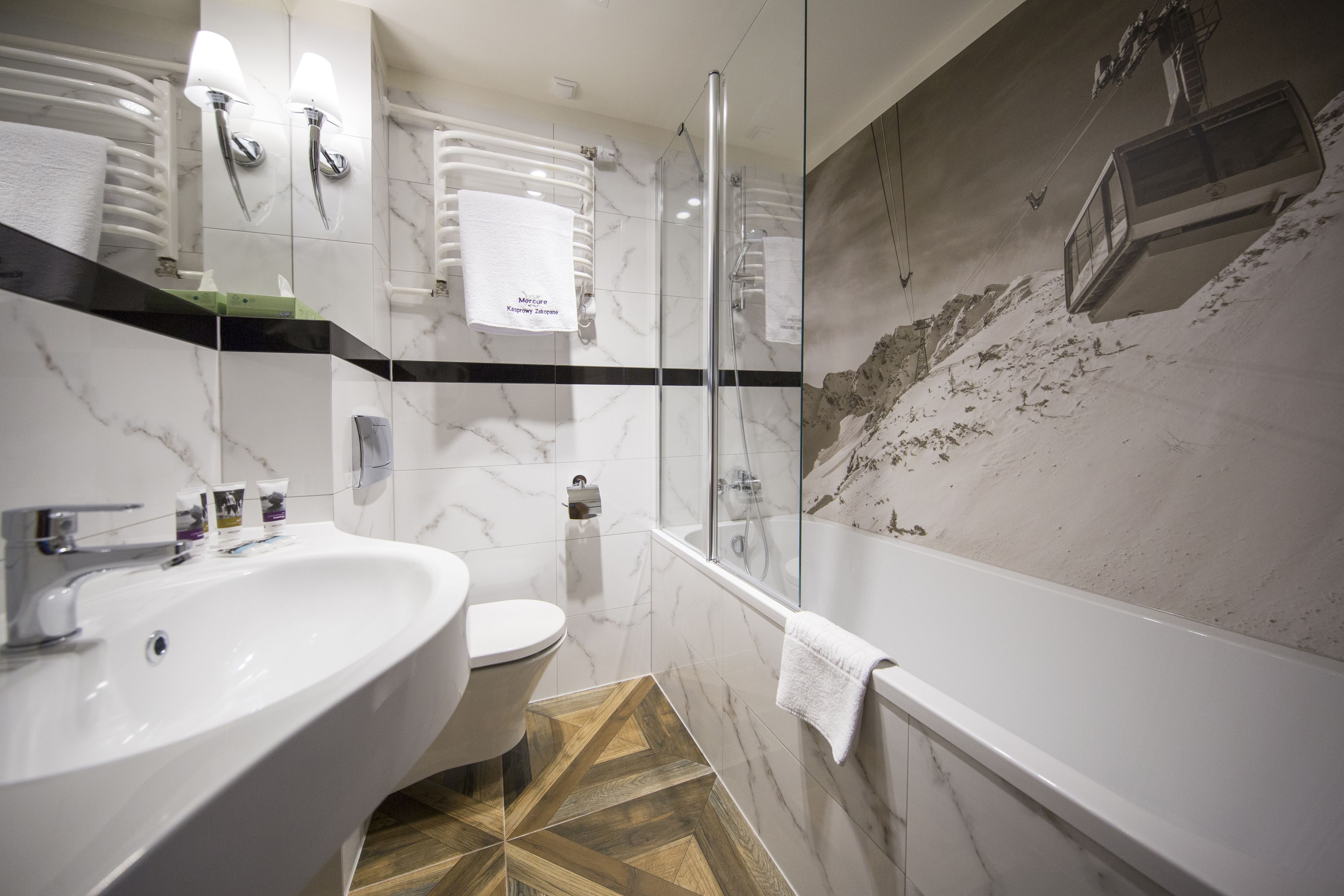 A modern bathroom with a large sink, toilet, and bathtub.