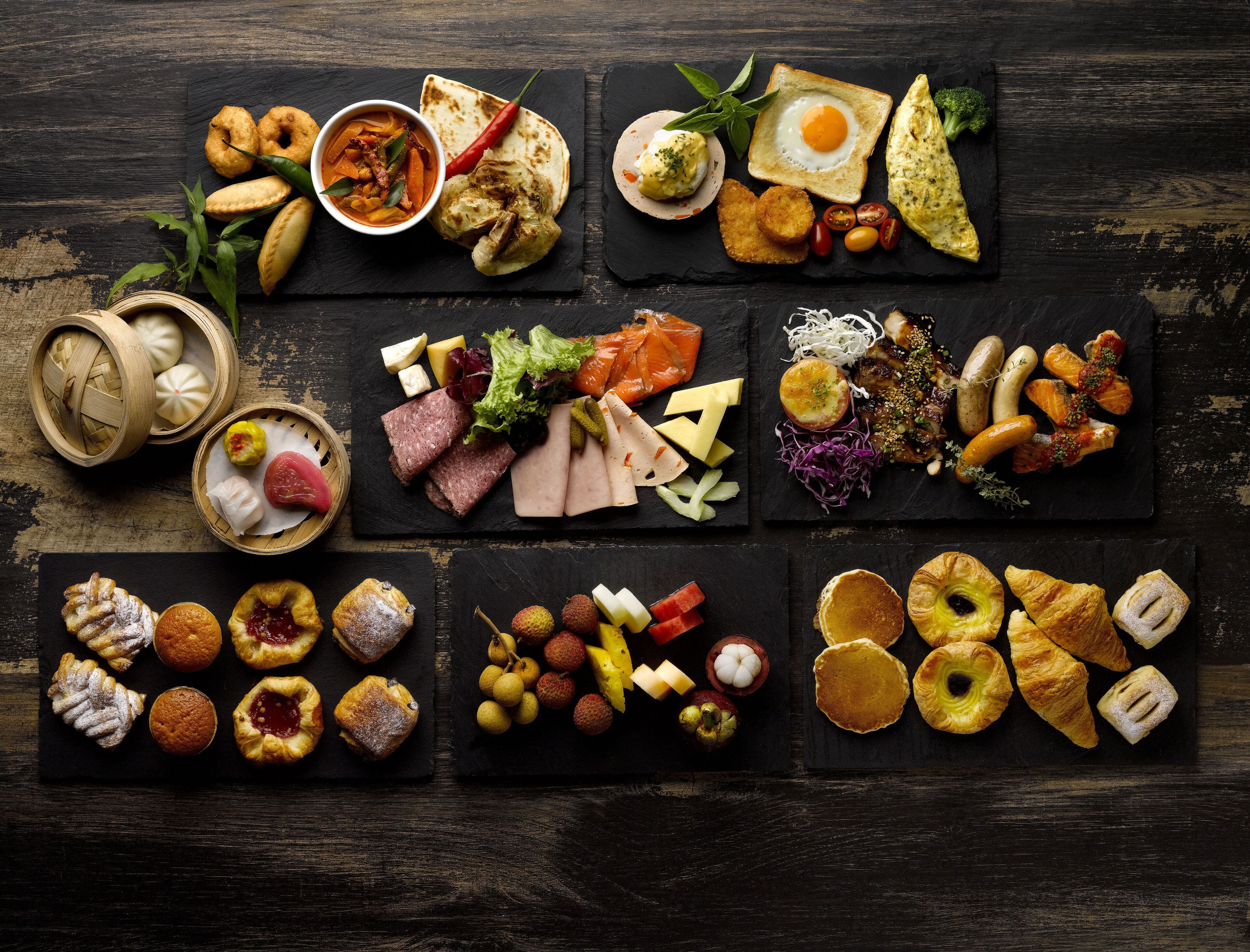 A variety of food items arranged on a wooden table.