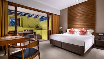A modern hotel room with a large bed, a desk, and a dining area.