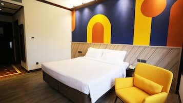 A modern hotel room with a large bed, a wooden headboard, and a vibrant abstract mural on the wall.