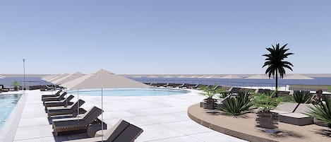 Een seizoensgebonden buitenzwembad, parasols voor strand/zwembad
