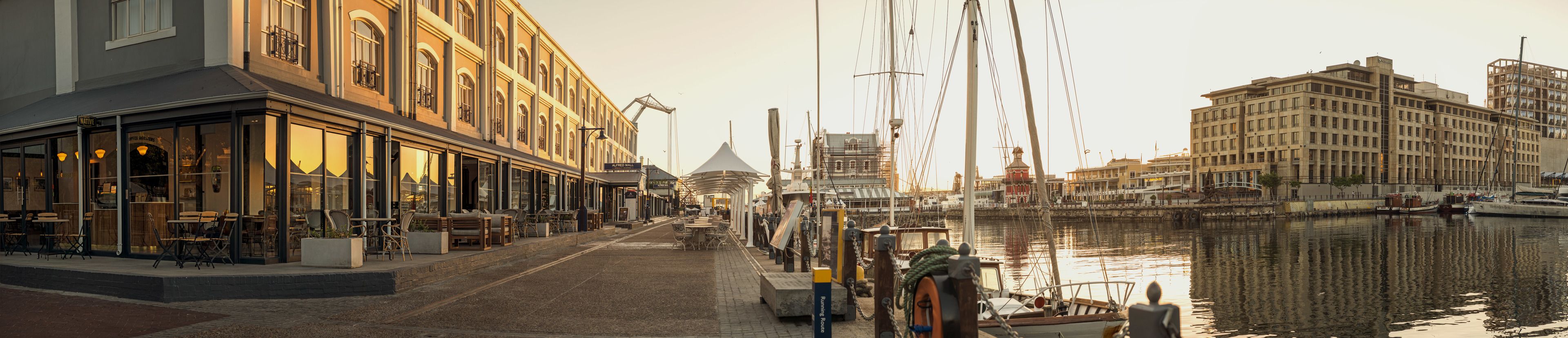 A waterfront building with outdoor seating and a view of the water.
