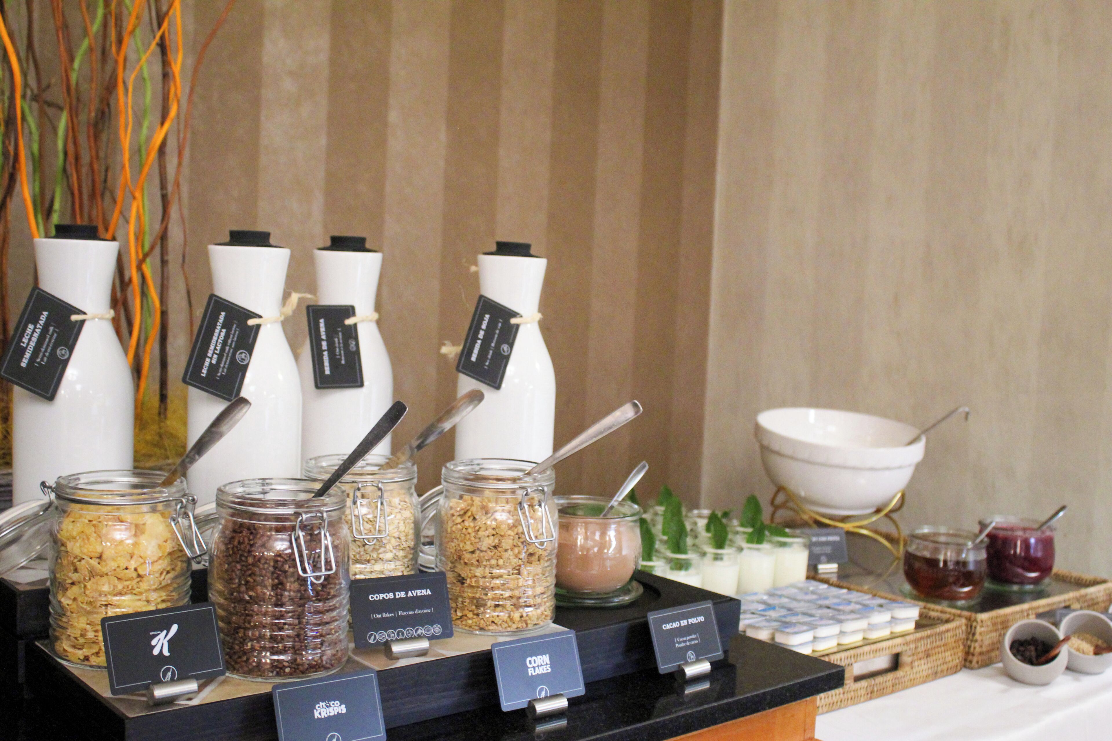 A buffet setup with various food items and condiments.