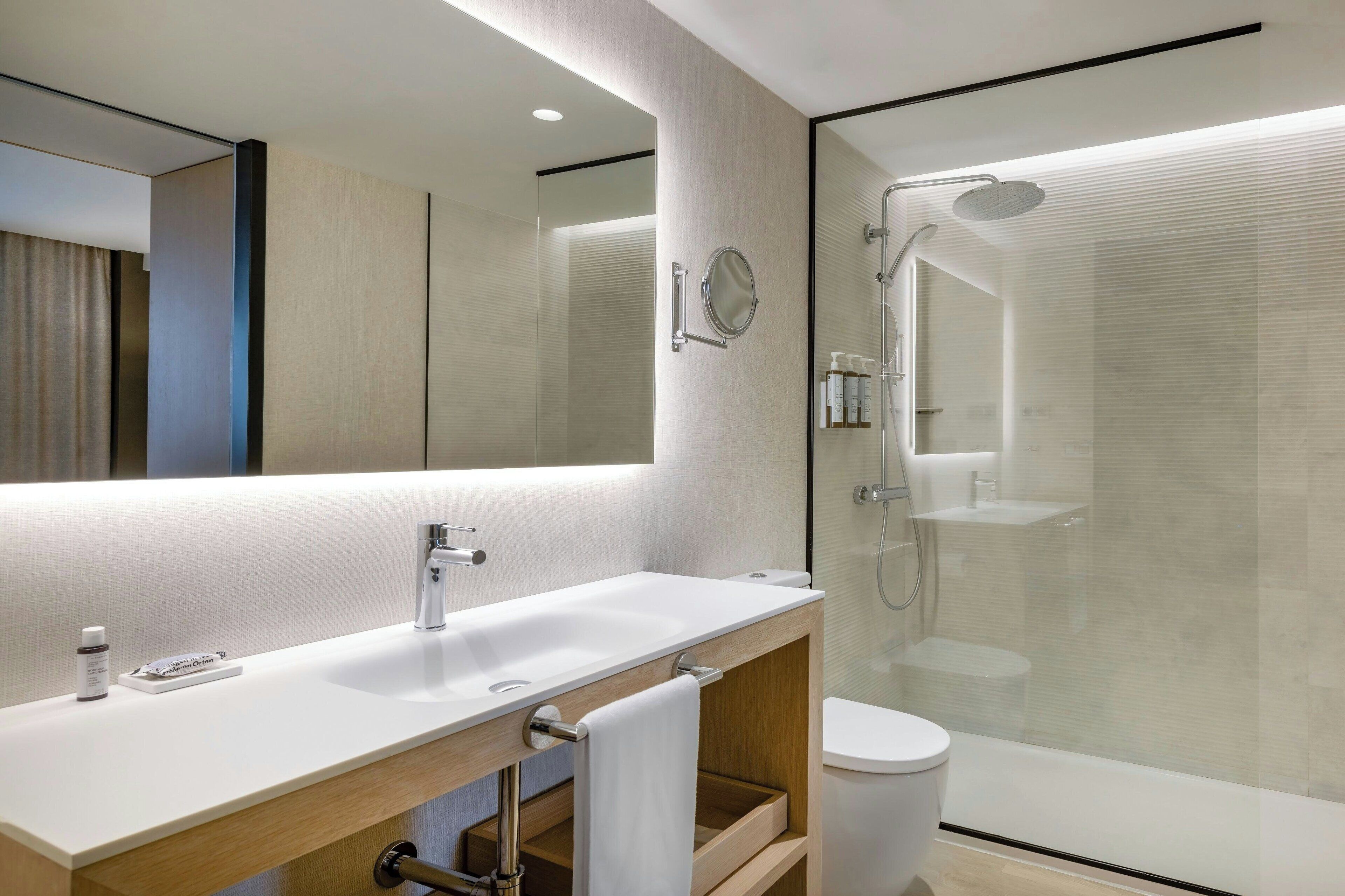 combined shower/bathtub, designer toiletries, hair dryer, bathrobes