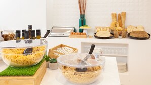 A buffet setup with various food items and condiments. - Hotel Macià Granada Five Senses Rooms & Suites (Granada)