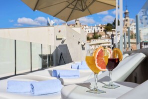Seasonal outdoor pool, open 10:00 AM to 11:00 PM, pool umbrellas