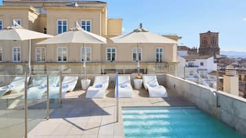 Seasonal outdoor pool, open 10:00 AM to 11:00 PM, pool umbrellas