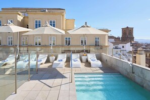 Seasonal outdoor pool, open 10:00 AM to 11:00 PM, pool umbrellas