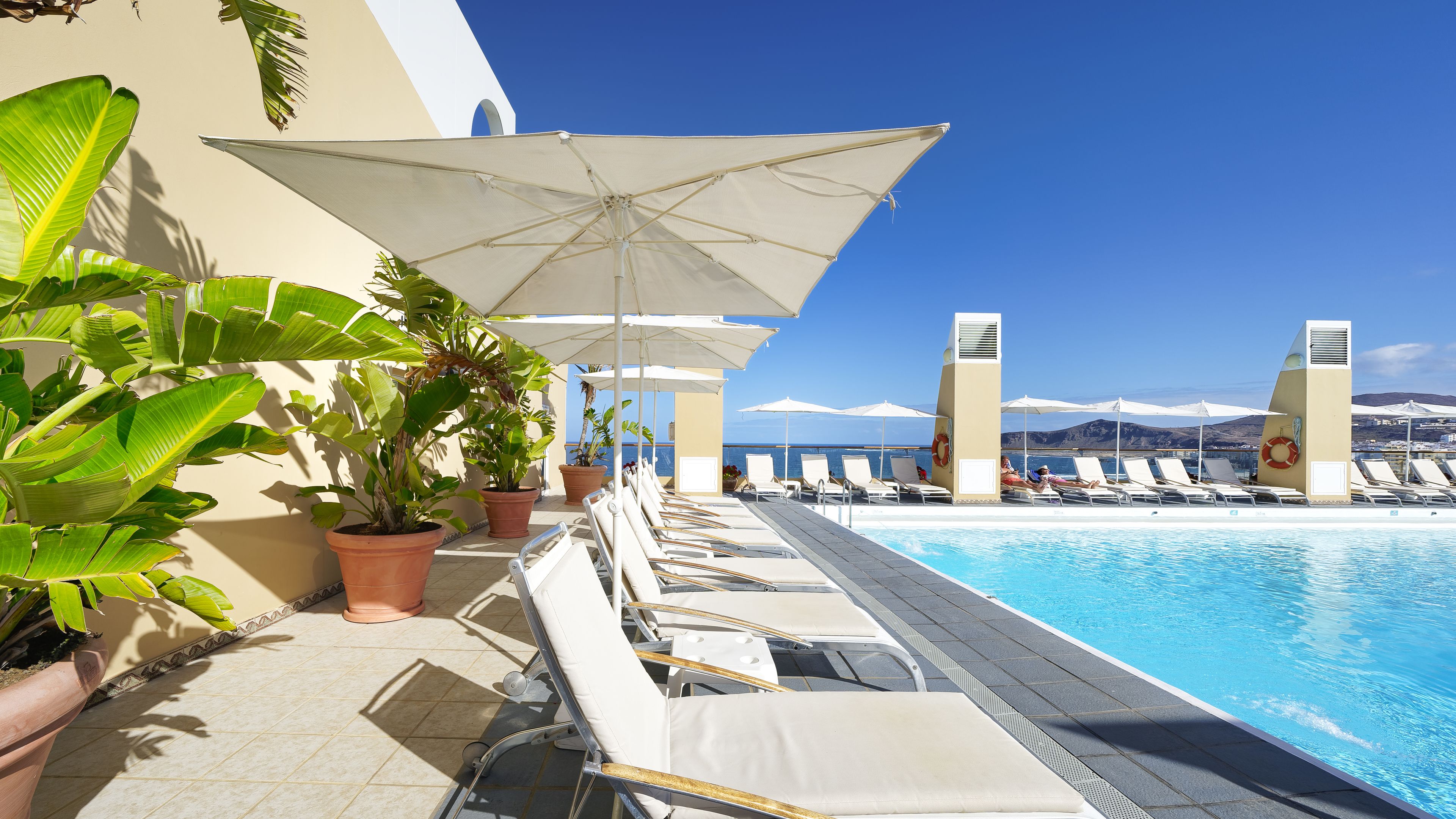 outdoor pool, pool umbrellas, pool loungers