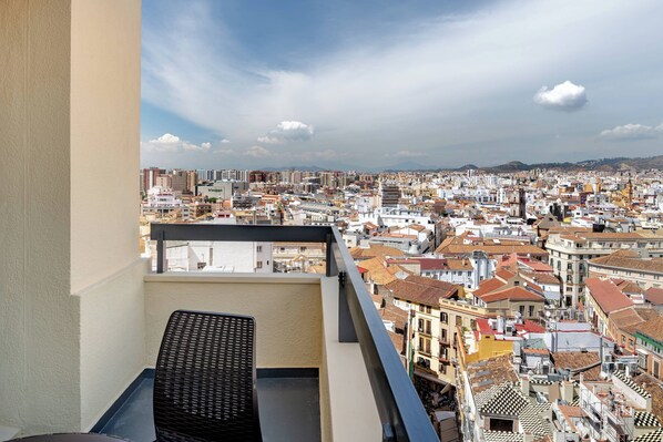 A balcony with a view of a densely packed cityscape, featuring a variety of building styles and a clear sky. - AC Hotel Málaga Palacio by Marriott (Málaga)